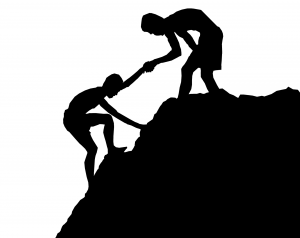 A person helping another person climb a steep hill